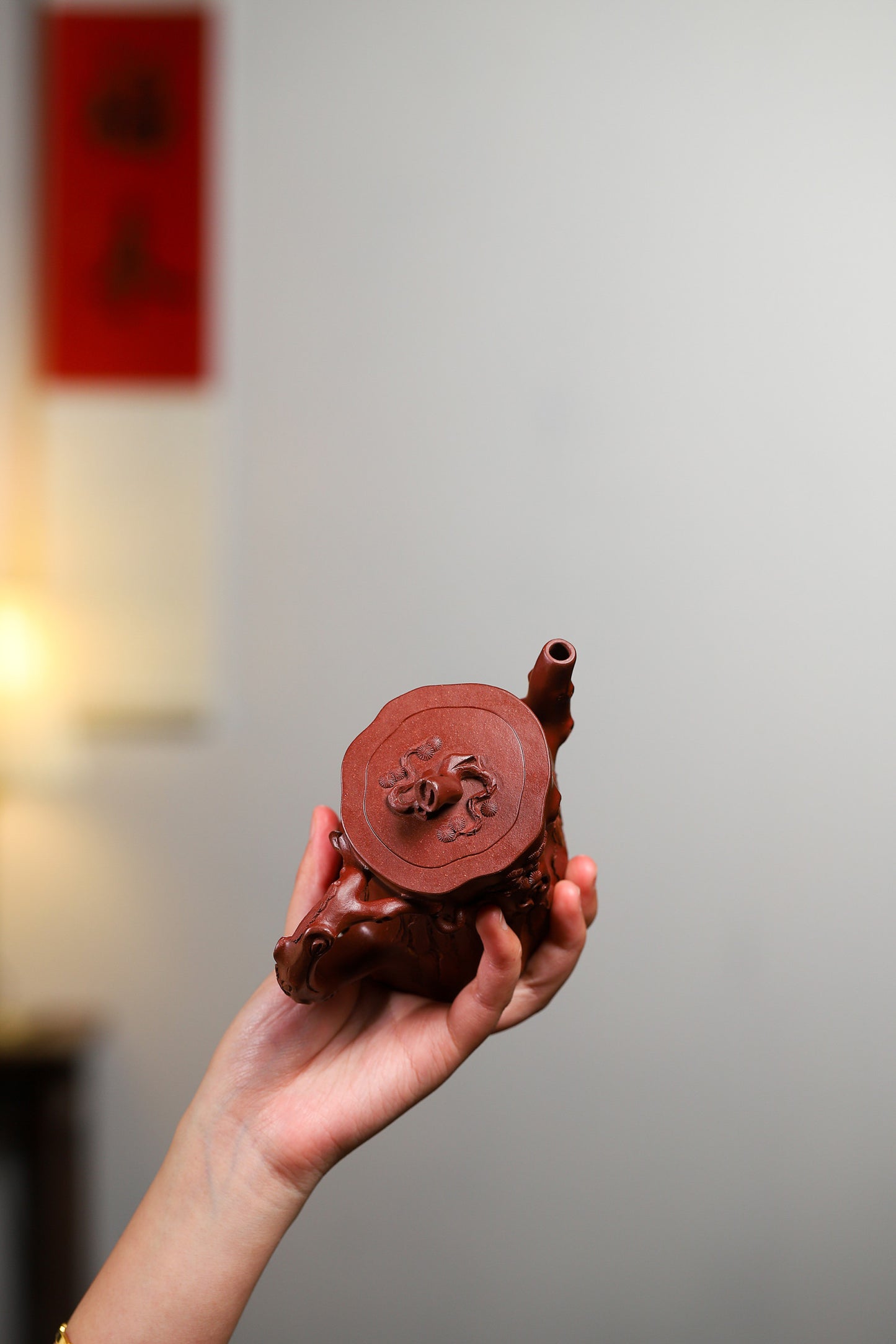 Handcrafted Yixing purple sand teapot resembling a pine tree, showcasing intricate design and craftsmanship.