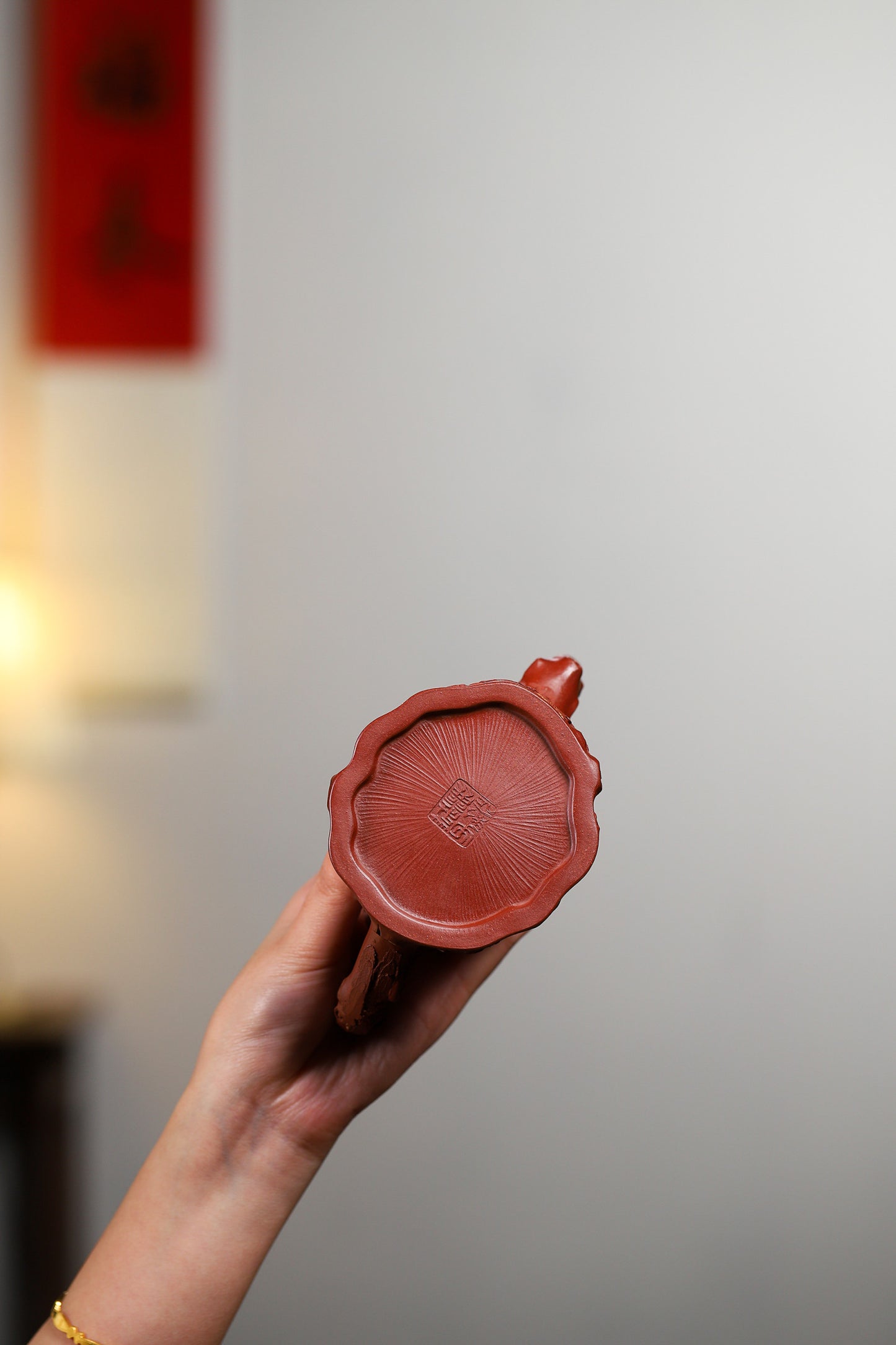Handcrafted Yixing purple sand teapot showcasing intricate base design, perfect for collectors and tea enthusiasts.
