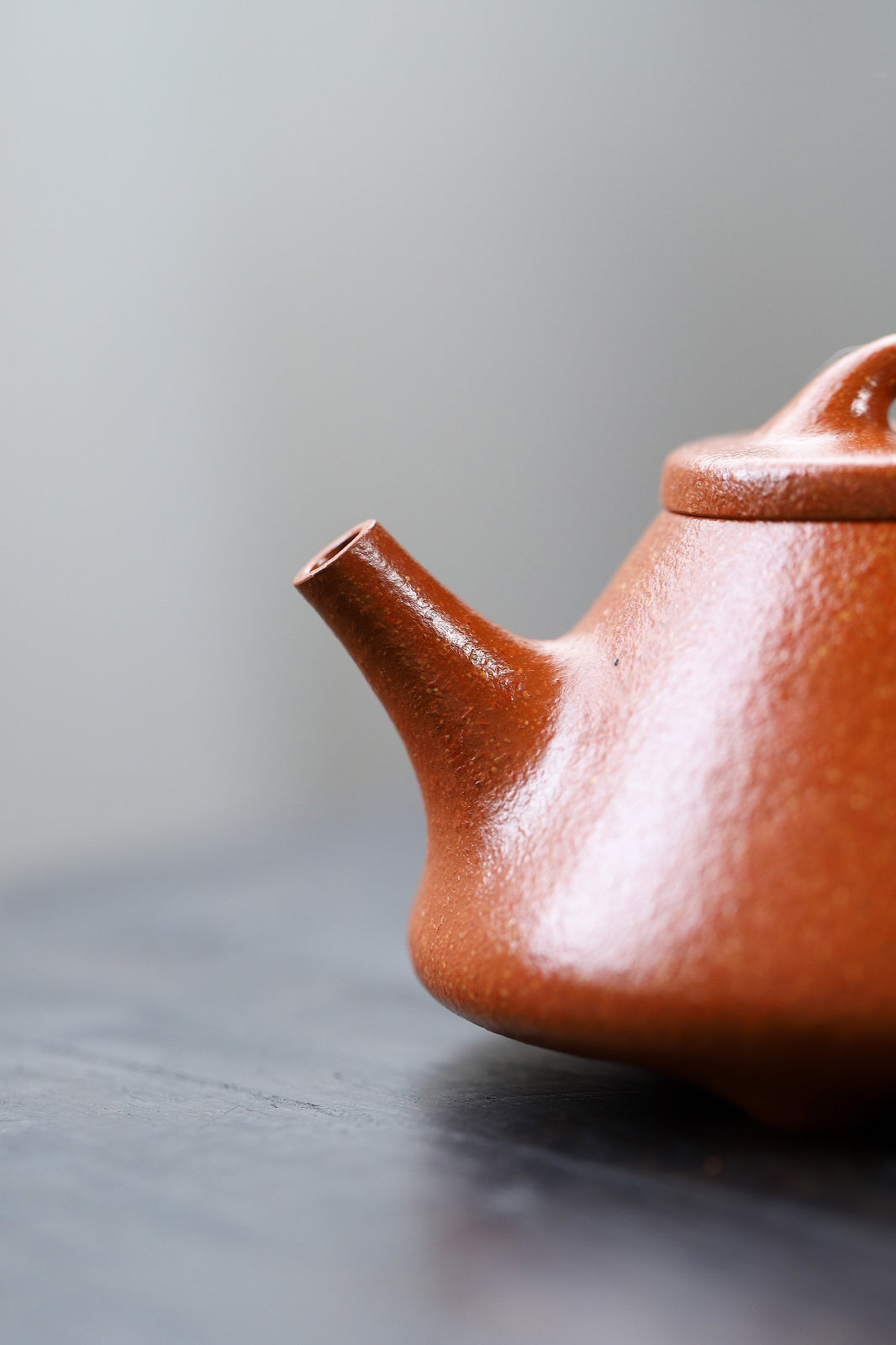 Handmade Yixing purple sand teapot with smooth finish and elegant spout design.