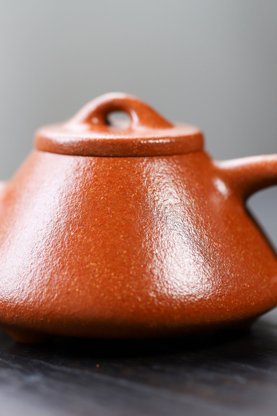 Handmade Yixing purple sand teapot with a smooth, rich red finish, showcasing traditional craftsmanship.