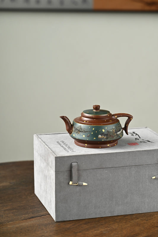 Handmade Yixing purple sand teapot on a gray box, showcasing fine craftsmanship and traditional design.