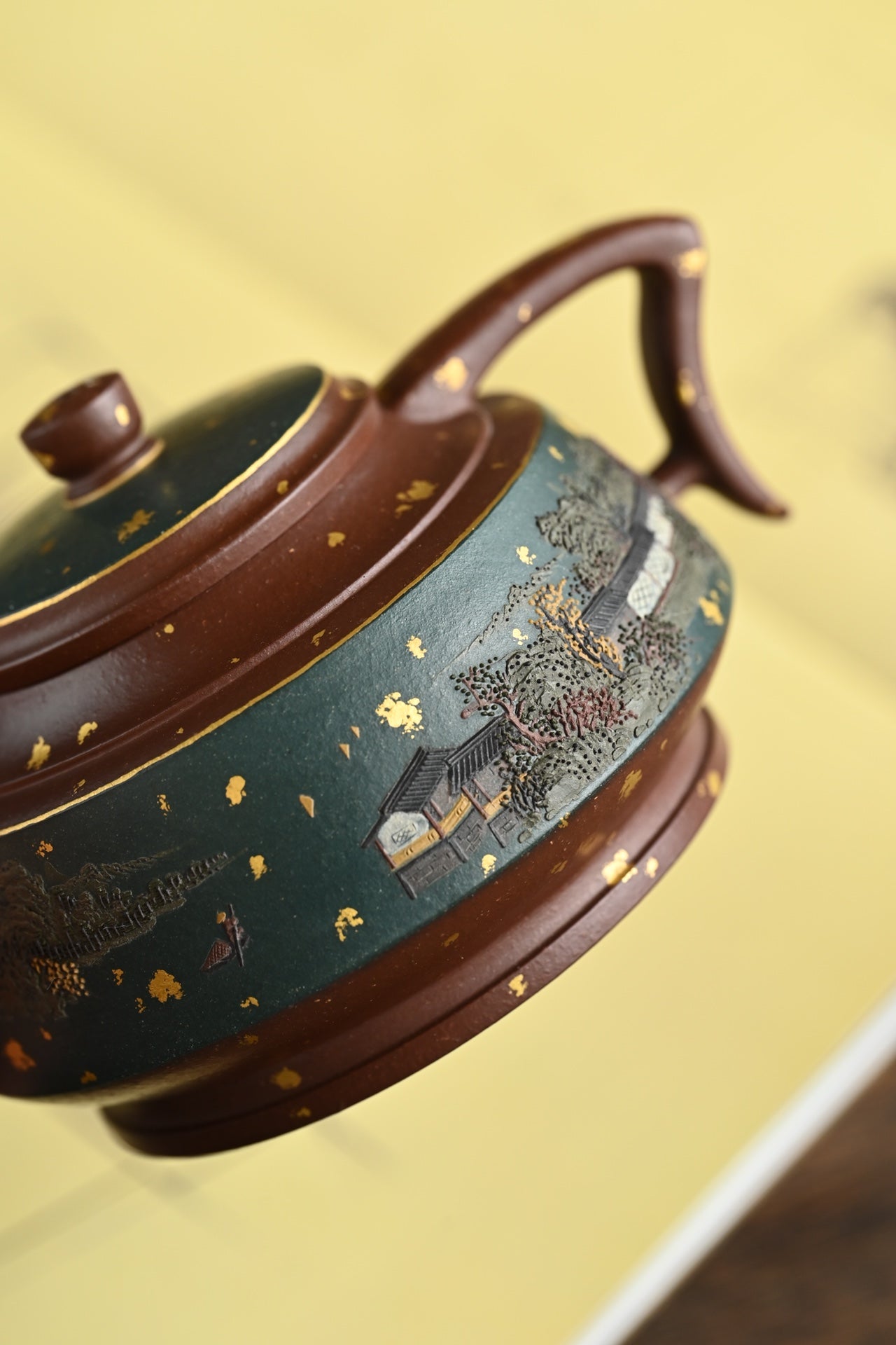 Handmade Yixing purple sand teapot featuring intricate decorations and elegant design, showcasing traditional craftsmanship.