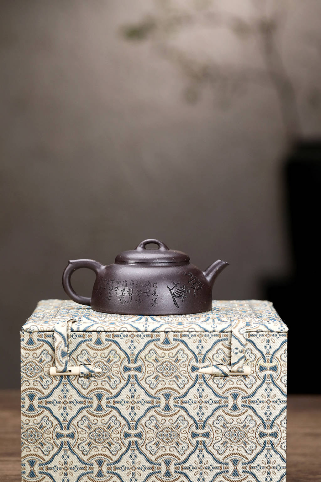 Handmade Yixing purple sand teapot in a decorative gift box, showcasing traditional craftsmanship and unique design.