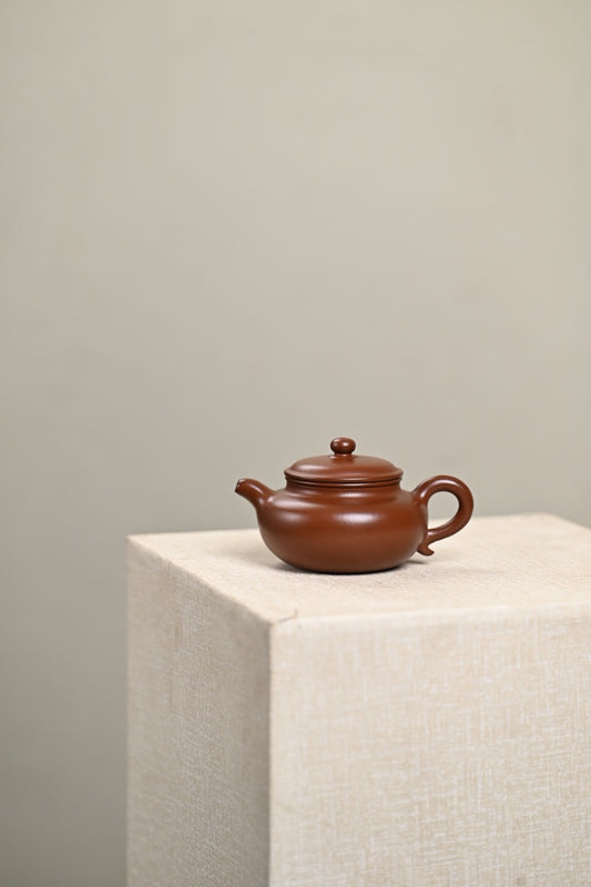 Handmade Yixing purple sand teapot, 150cc capacity, showcasing traditional craftsmanship and elegant design.