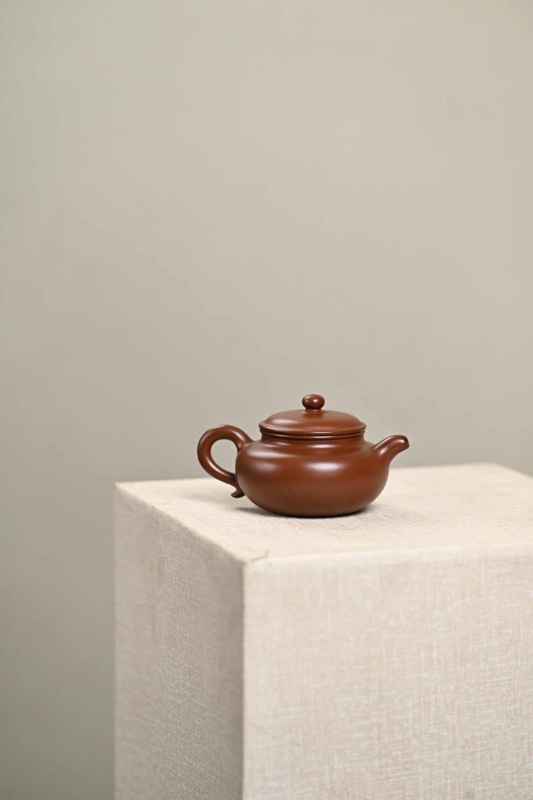 Handmade Yixing purple sand teapot on display, showcasing traditional craftsmanship and elegance.