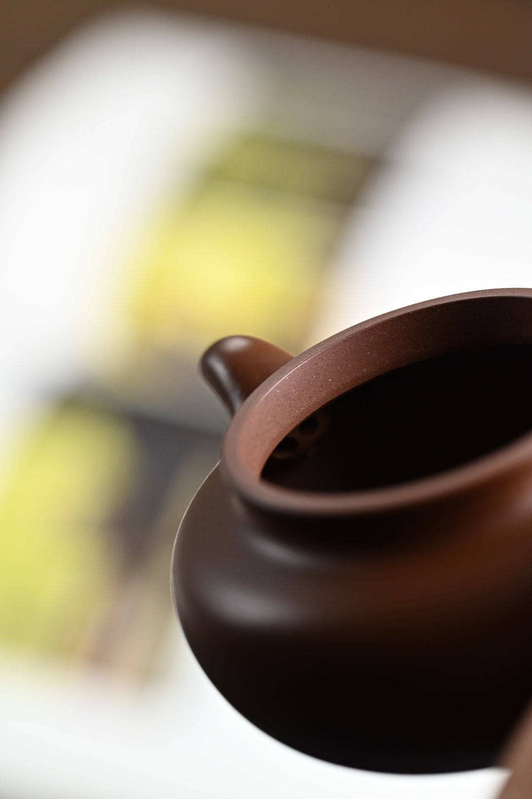 Handmade Yixing purple sand teapot with a vintage design and a smooth finish, capturing craftsmanship details.