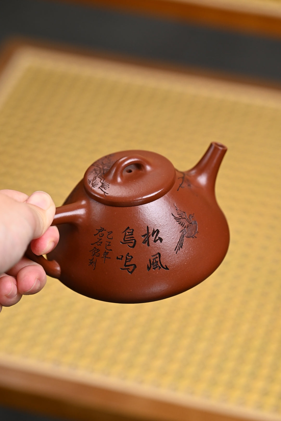 Handmade Yixing purple sand teapot featuring intricate designs, showcasing traditional craftsmanship.