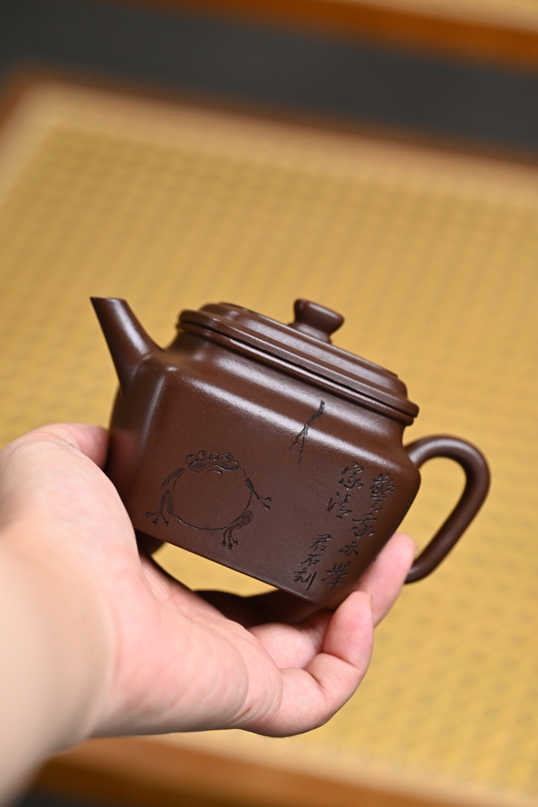 Handmade Yixing purple sand teapot with intricate design, showcasing craftsmanship by national master artisan.