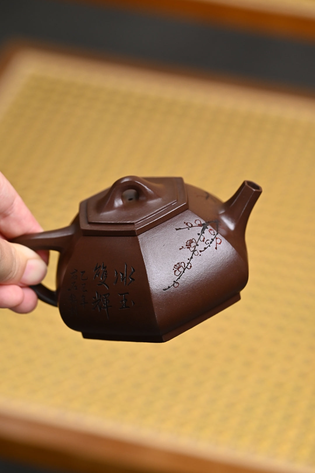 Handmade Yixing purple sand teapot, featuring intricate designs and artisan craftsmanship.