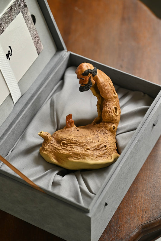 Handmade Yixing purple sand teapot in a gift box, showcasing unique craftsmanship by a skilled artisan.