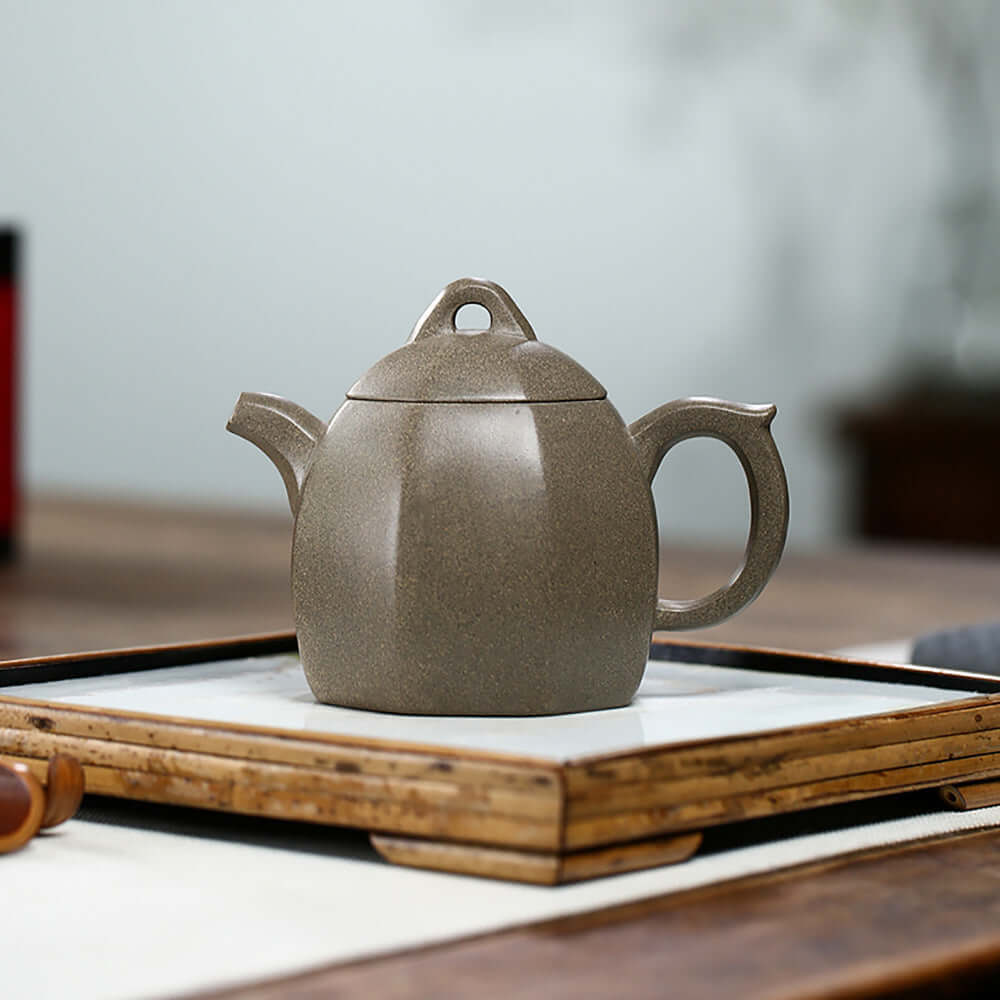 Handmade Yixing purple sand teapot in a unique design, ideal for tea lovers and as a high-end gift.
