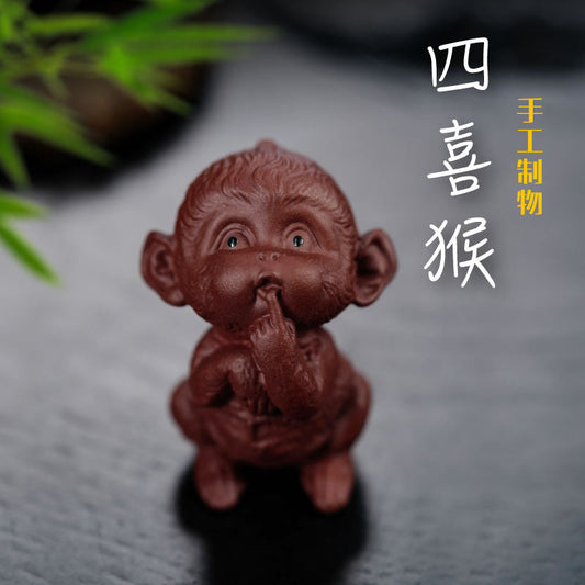 Handmade Yixing purple sand tea pet sculpture of a monkey, perfect for tea table decoration.