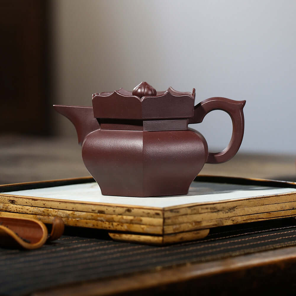 Handmade Yixing purple sand teapot with unique square design, ideal for tea enthusiasts and collectors.