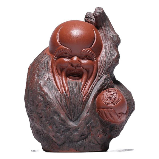 Handmade Yixing purple sand tea pet figurine, depicting a joyful deity for tea ceremony decoration.