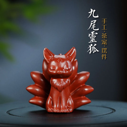 Handmade Yixing purple sand nine-tailed fox sculpture, a creative tea table accessory for tea lovers.