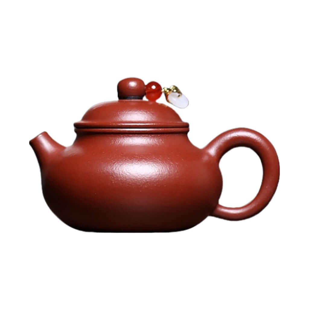 Handmade Yixing purple sand teapot with a traditional design and decorative handle, perfect for Kung Fu tea sets.
