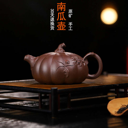 Handmade Yixing purple sand teapot in pumpkin shape, crafted by skilled artisans, perfect for home tea brewing.