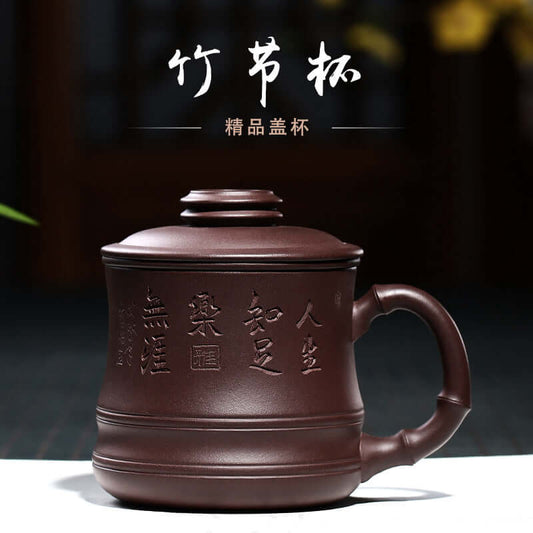 Handmade Yixing purple sand teapot with intricate designs, showcasing craftsmanship and tradition.