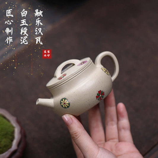 Handmade Yixing purple sand teapot with floral design, crafted by artisans, perfect for Kung Fu tea set.