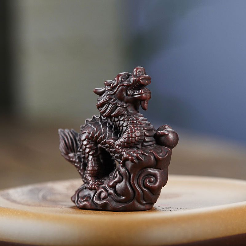 Handmade Yixing purple sand dragon tea pet ornament for tea ceremonies, crafted by skilled artisans.