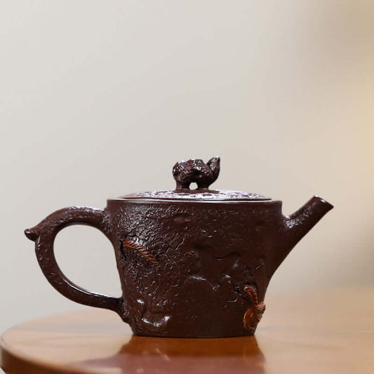 Handmade Yixing purple sand teapot with intricate design, showcasing traditional craftsmanship and unique artistry.