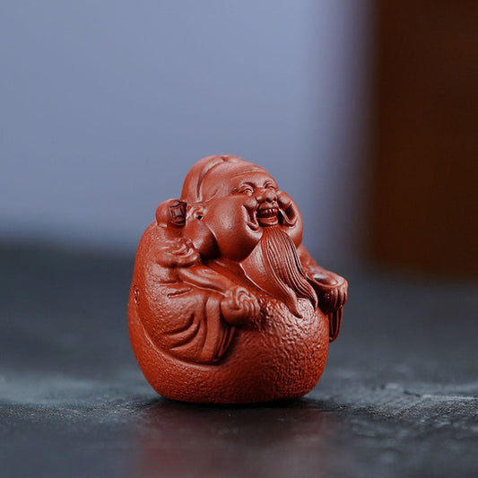 Handmade Yixing purple sand tea pet ornament of the God of Wealth, ideal for tea lovers and Kung Fu tea set enthusiasts.