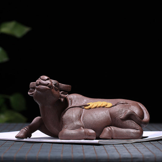 Handmade Yixing purple sand tea pet in the shape of a cow, symbolizing wealth and blessings, perfect for tea ceremony decoration.