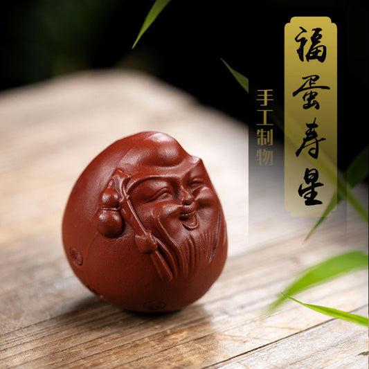 Handmade Yixing purple sand tea pet ornament, happy egg design, perfect for tea sets and gifting.