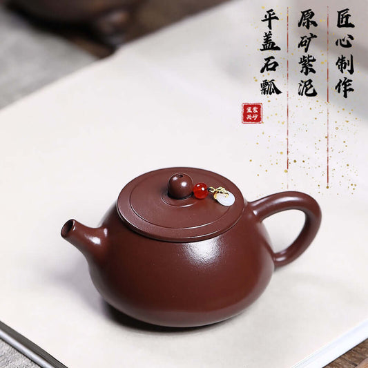 Handmade Yixing purple sand teapot with flat lid and stone scoop, perfect for Kung Fu tea brewing at home.