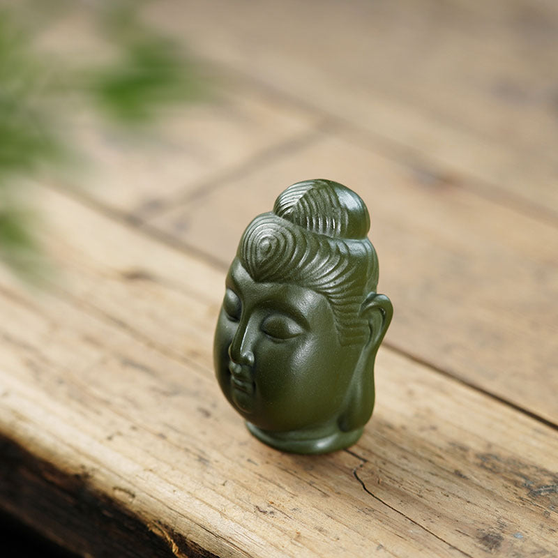 Handmade Yixing purple sand Buddha head ornament, perfect for decoration and tea pet collections.
