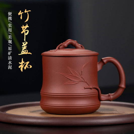 Handmade Yixing purple sand cup with bamboo design, perfect for tea lovers and collectors.