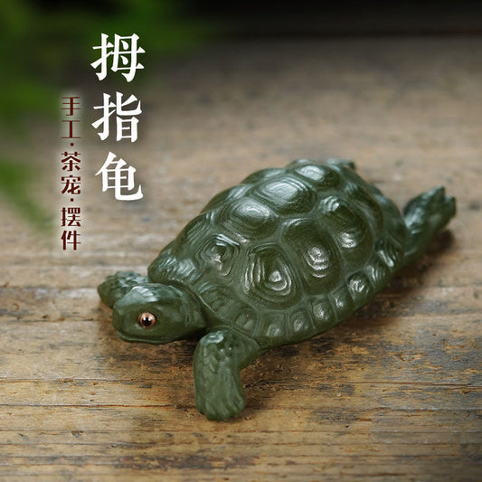 Handmade Yixing purple sand turtle sculpture, ideal for tea table decor and creative tea play. Unique green mud ornament.