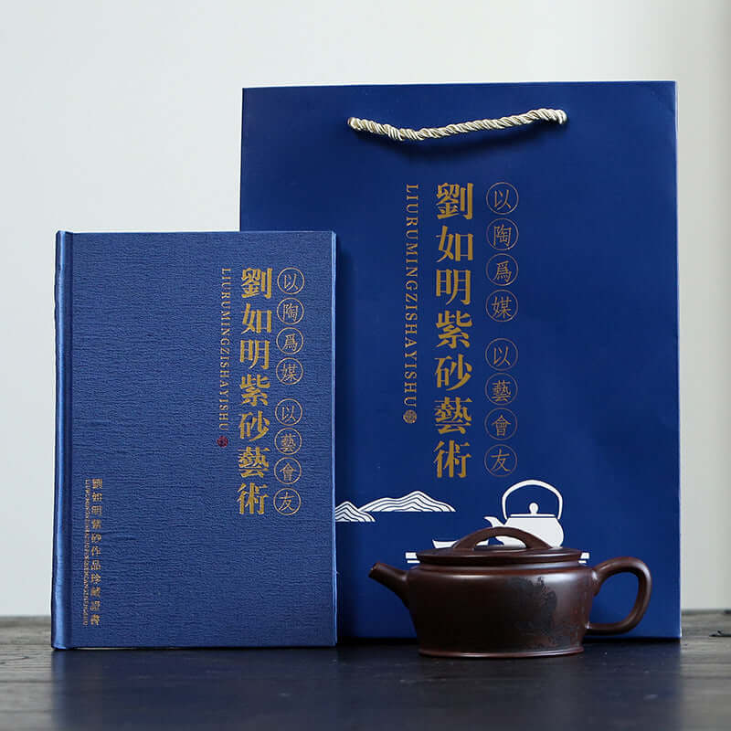 Handmade Yixing purple sand teapot with decorative box and bag, showcasing traditional Chinese craftsmanship.