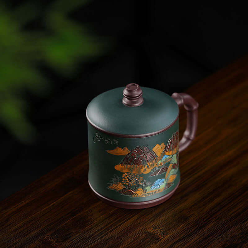 Handmade Yixing purple sand tea cup featuring landscape engraving, perfect for office use.