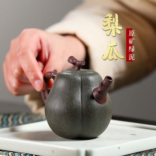 Handmade Yixing purple sand teapot in pear melon shape, showcasing artisanal craftsmanship and unique design.