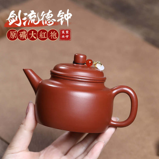 Handmade Yixing purple sand teapot featuring traditional design and intricate craftsmanship, perfect for home kung fu tea sets.