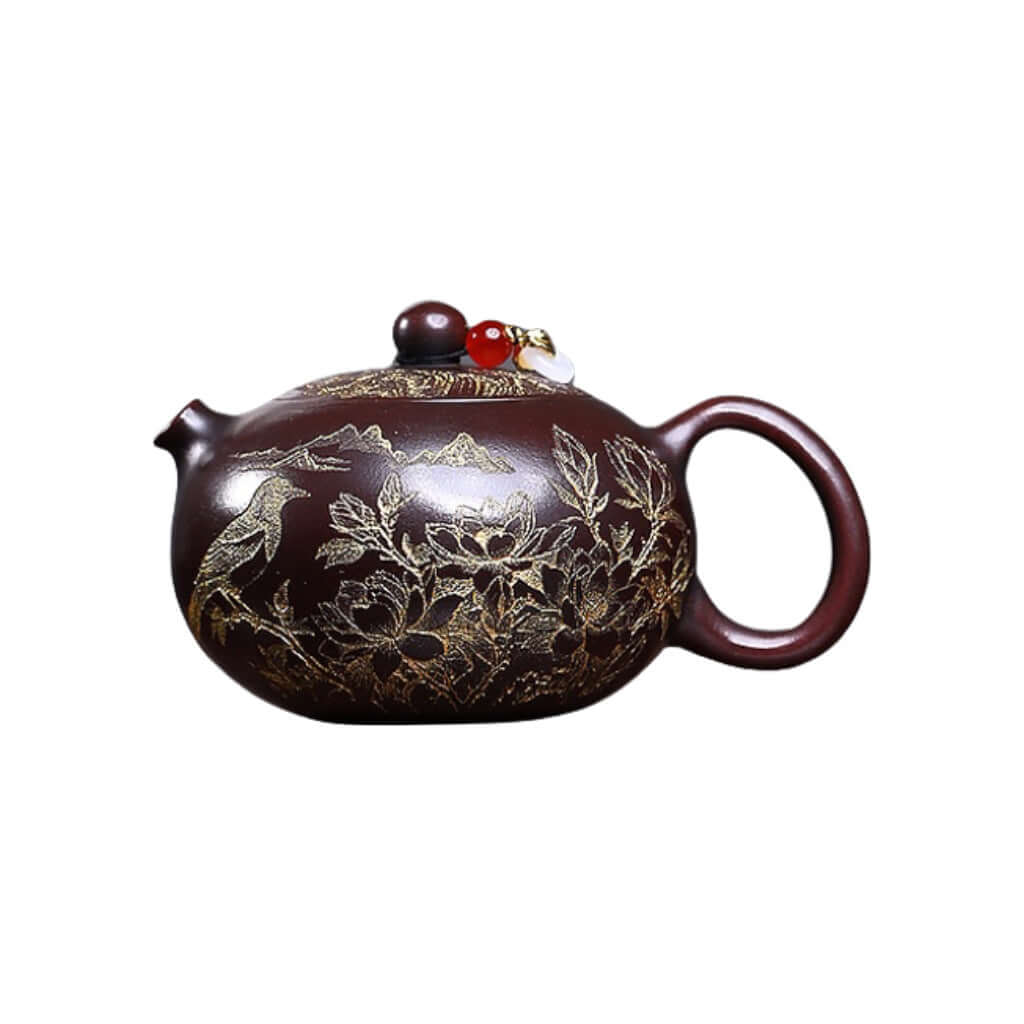 Handmade Yixing purple sand teapot with intricate floral and bird carvings, perfect for tea enthusiasts.