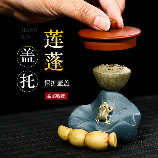 Handmade Yixing purple sand tea pet decoration featuring a frog on a lotus leaf pedestal.