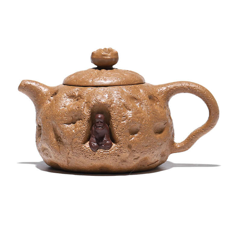 Handmade Yixing purple sand teapot with unique trunk-like design and bud flower lid, featuring a carved figure.