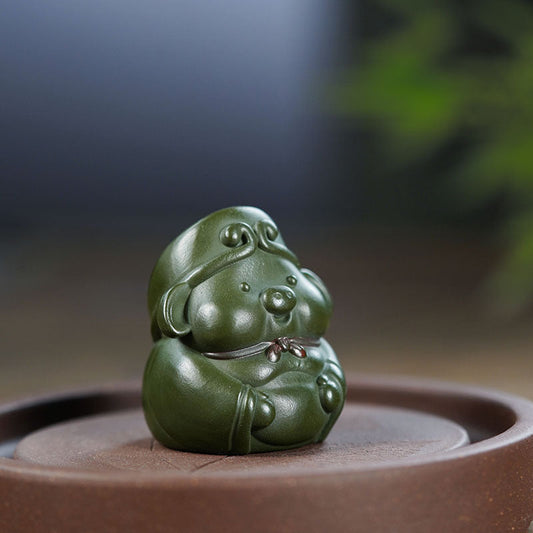 Handmade Yixing purple sand tea pet sculpture, green mud Bajie figurine for tea table decor, crafted by Yixing artisans.