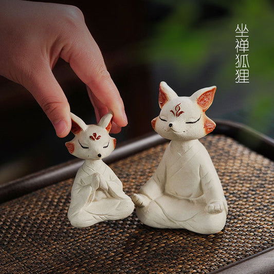 Handmade Yixing purple sand tea pet fox sculptures, perfect for tea tables and Zen decor, showcasing craftsmanship and creativity.