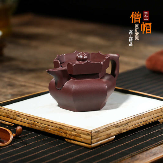 Handmade Yixing purple sand teapot with intricate design, showcasing high-end craftsmanship in a traditional setting.