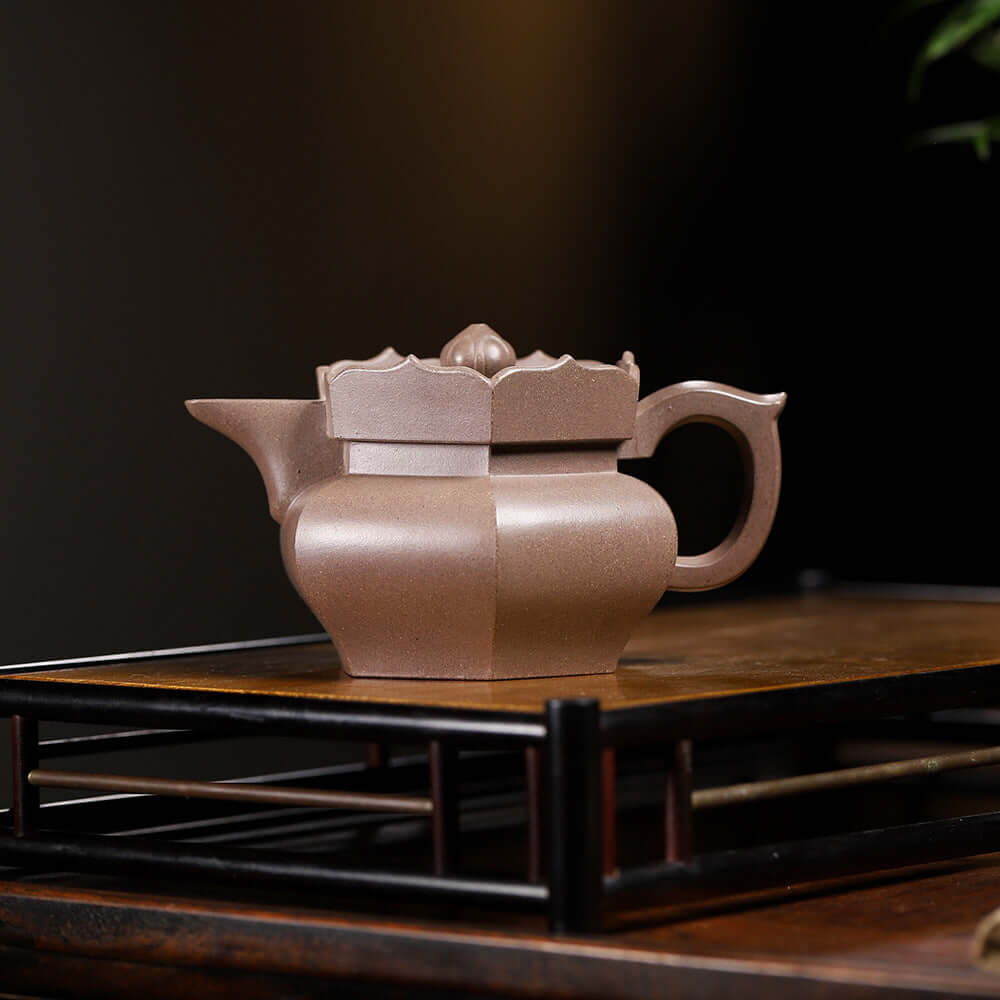 Handmade Yixing purple sand teapot on display, showcasing its unique craftsmanship and elegant design.