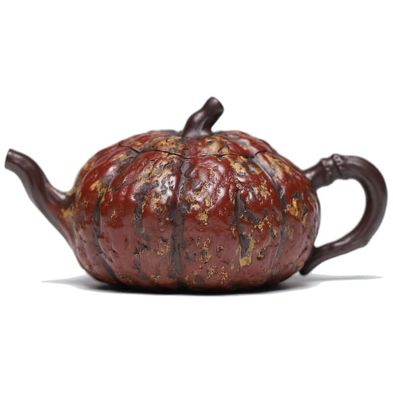 Handmade Yixing purple sand teapot in pumpkin shape, featuring detailed carvings and a graceful handle.