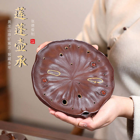 Handmade Yixing purple sand lotus pot bearing tea set accessory, showcasing intricate details and craftsmanship.