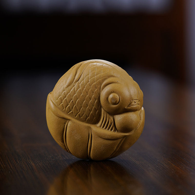 Handmade Yixing purple sand tea pet ornament shaped like a fish, perfect for tea enthusiasts and collectors.