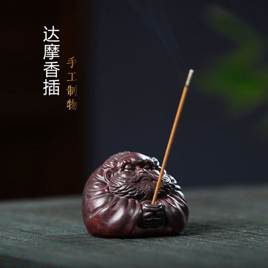 Handmade Yixing purple sand Daruma incense holder, beautifully carved for tea pet health. Unique gift for fitness enthusiasts.