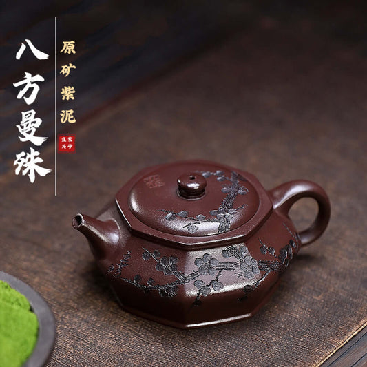 Handmade Yixing purple sand teapot with plum blossom engraving, showcasing original purple clay craftsmanship.