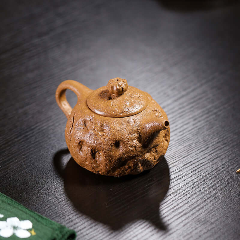 Handmade Yixing purple sand teapot featuring a unique texture and design, perfect for tea enthusiasts.