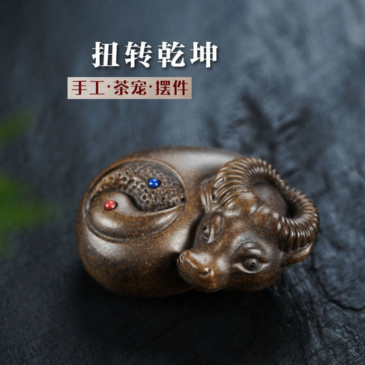 Handmade Yixing purple sand ox ornament for tea play, crafted by Yixing artisans, showcasing traditional Tai Chi Bagua design.